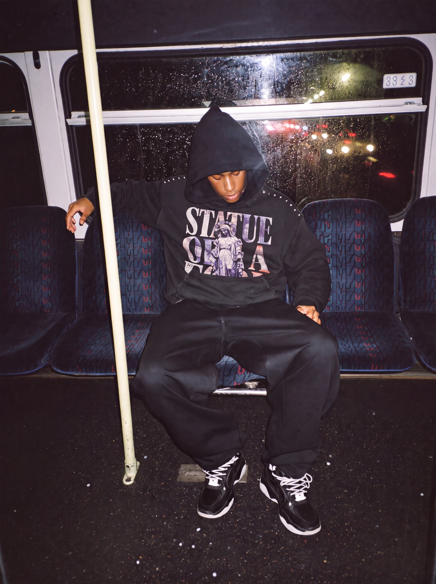 Statue of a Fool campaign: night bus, hood