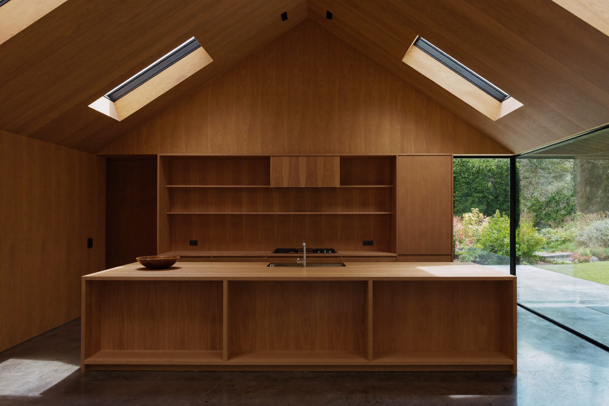 A vaulted oak kitchen with two roof lights and a long island